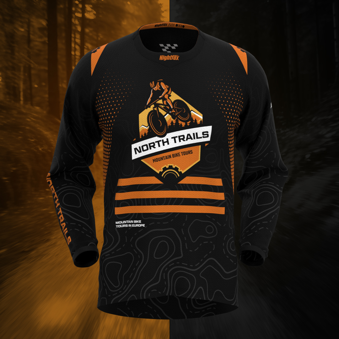 Custom jersey design mockup for North Trails MTB tour company in Spain with black and orange accents.