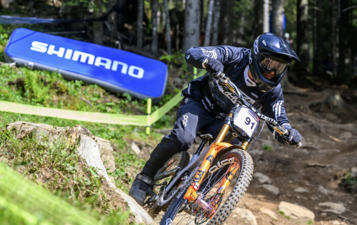 Outlaw United MTB Team competing in a World Cup race, wearing their fresh custom jerseys.