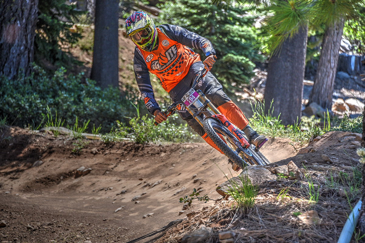 Ignite MTB team rider racing in custom kit, demonstrating the importance of the right wheel size for mountain biking