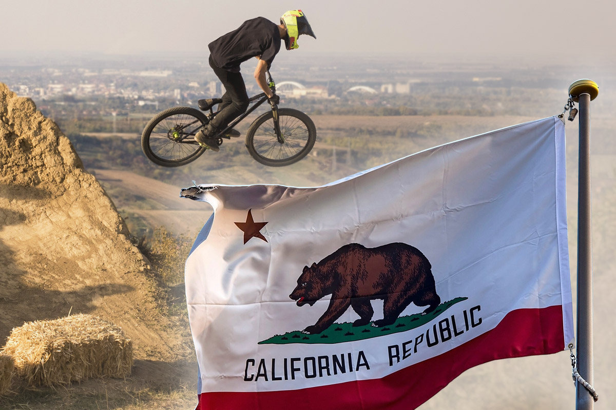 A mountain biker riding on a California trail with the California state flag prominently displayed in the foreground.