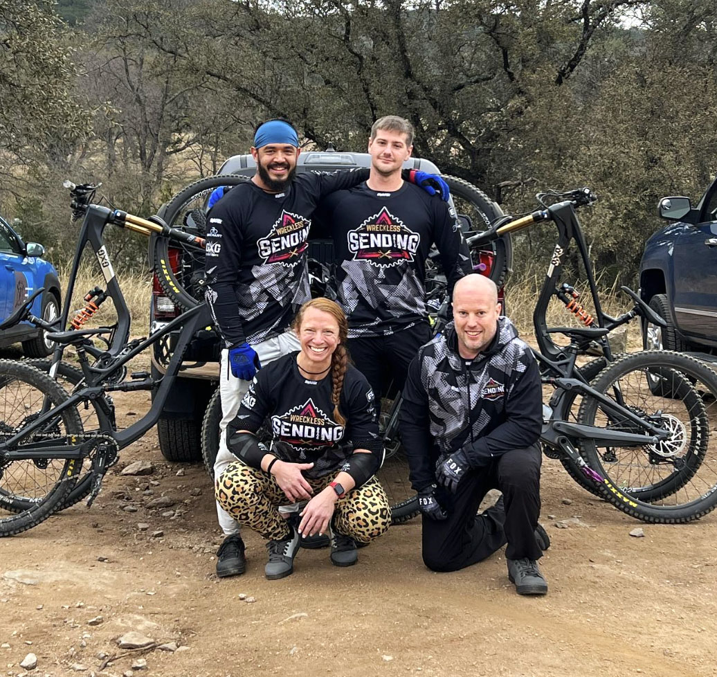 Wreckless Sending team photo with riders wearing their custom MTB jerseys.