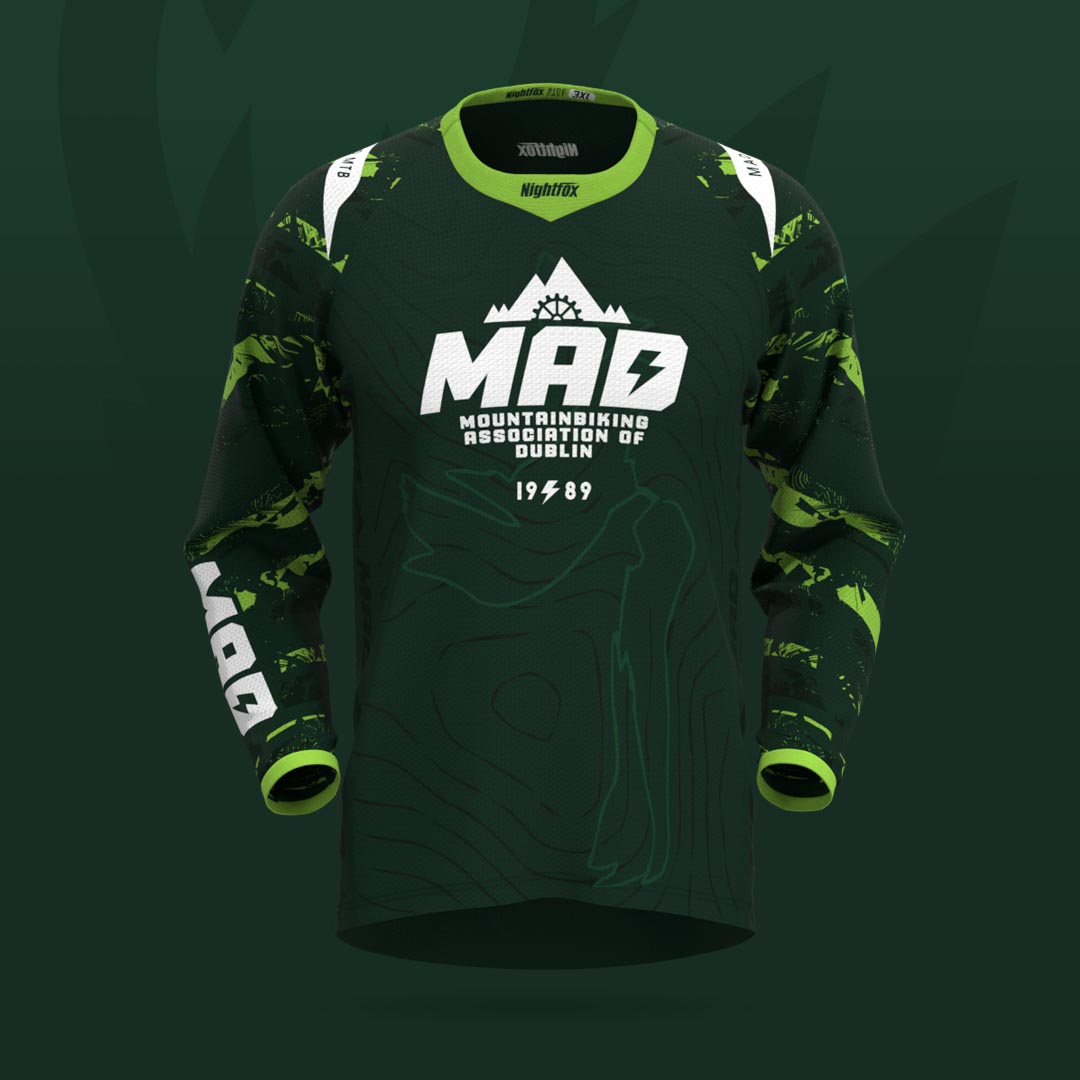 Team MAD MTB's new forest green jersey with bright green accents and abstract pattern, featuring individual names on the back.